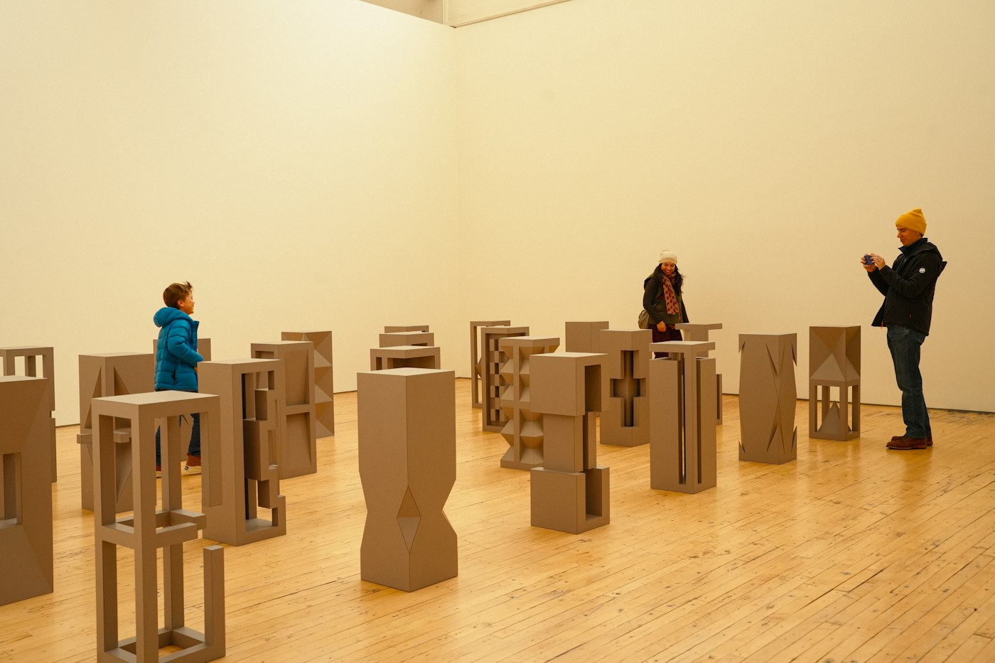 People exploring abstract forms in an art gallery